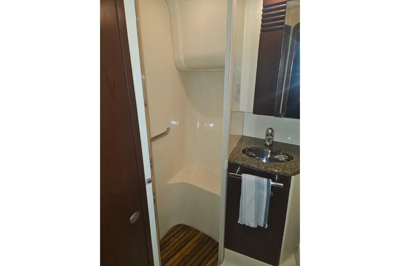 Sea Trials Yacht Photos Pics 2007 Sea Ray 44 Sedan Bridge bathroom with shower, sink, and wooden floor mat.