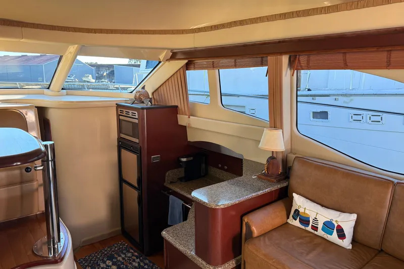 Sea Trials Yacht Photos Pics Interior of 2007 Sea Ray 44 Sedan Bridge yacht with cozy seating and kitchenette.