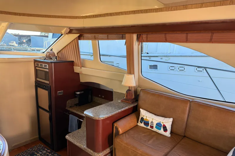Sea Trials Yacht Photos Pics Interior of 2007 Sea Ray 44 Sedan Bridge yacht with cozy seating and kitchenette.