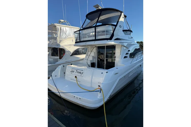 Sea Trials Yacht Photos Pics 2007 Sea Ray 44 Sedan Bridge yacht docked at marina, rear view.