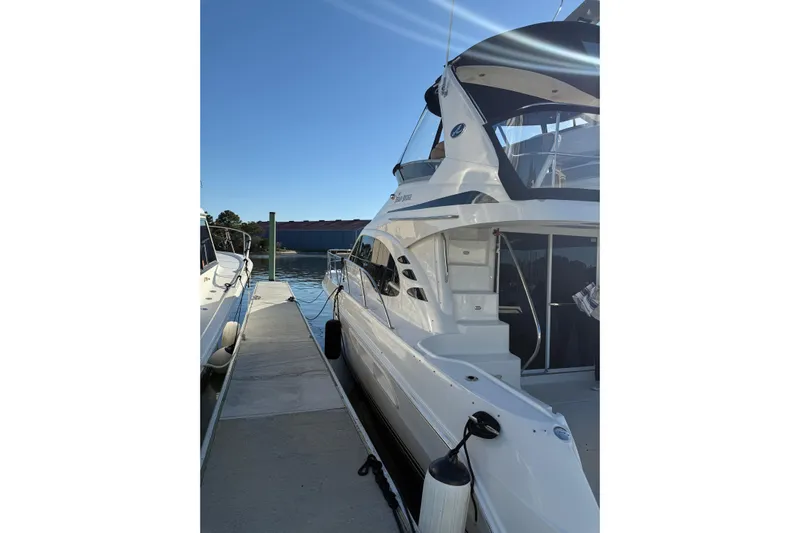 Sea Trials Yacht Photos Pics 2007 Sea Ray 44 Sedan Bridge yacht docked at marina under clear blue sky.