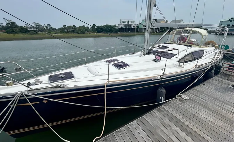 Charisapa Yacht Photos Pics 2012 Jeanneau 50 DS sailboat docked by a wooden pier.