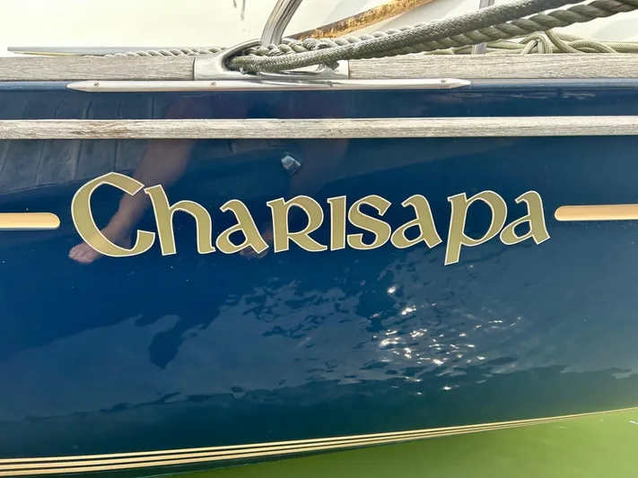 Charisapa Yacht Photos Pics Jeanneau 50 DS 2012 sailboat named "Charisapa" with blue hull and gold lettering.