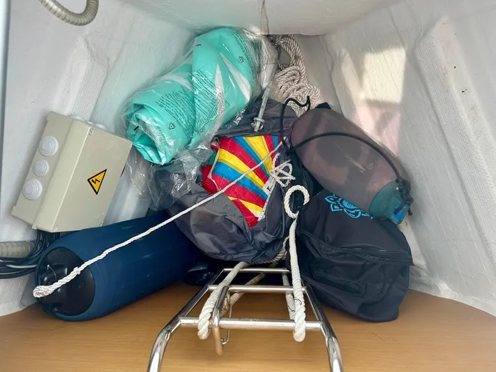 Charisapa Yacht Photos Pics Storage compartment on a 2012 Jeanneau 50 DS sailboat with ropes and equipment.