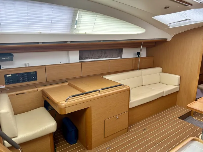 Charisapa Yacht Photos Pics Interior of 2012 Jeanneau 50 DS yacht with beige seating and wooden finishes.