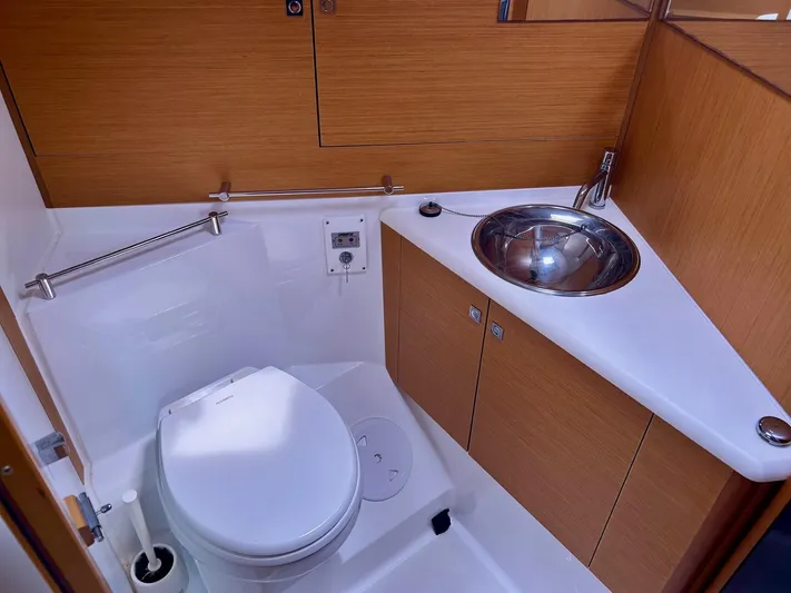 Charisapa Yacht Photos Pics Bathroom of 2012 Jeanneau 50 DS yacht with modern fixtures and wooden cabinetry.