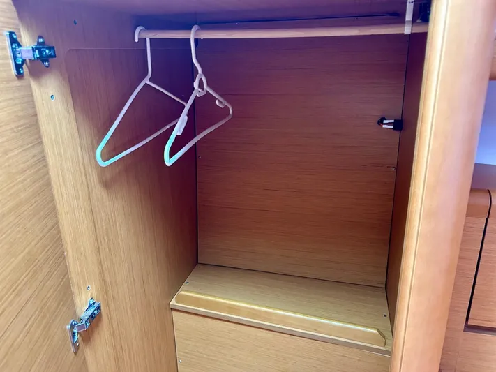 Charisapa Yacht Photos Pics Empty wooden closet with hangers on Jeanneau 50 DS, 2012 model.