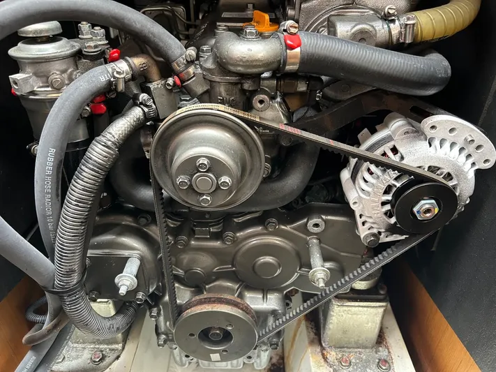Charisapa Yacht Photos Pics Engine of a 2012 Jeanneau 50 DS sailboat, showcasing belts and hoses.