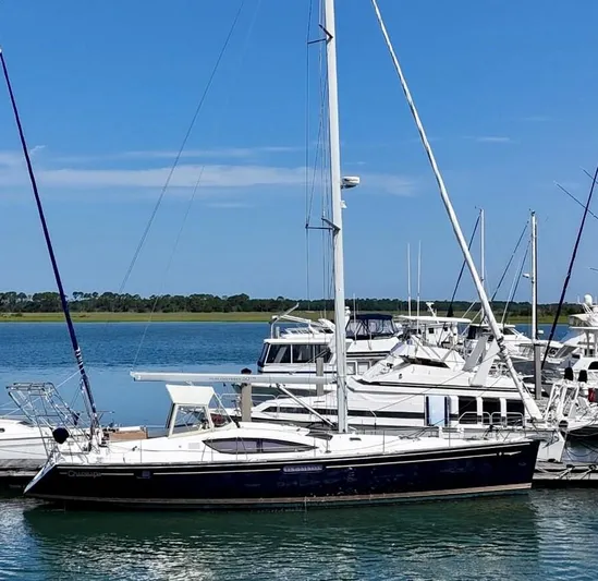 Charisapa Yacht Photos Pics 2012 Jeanneau 50 DS sailboat docked in a marina under clear blue skies.