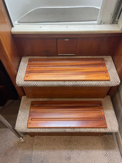  Yacht Photos Pics Staircase inside 2000 Carver 506 Motor Yacht with wooden steps and carpeted edges.