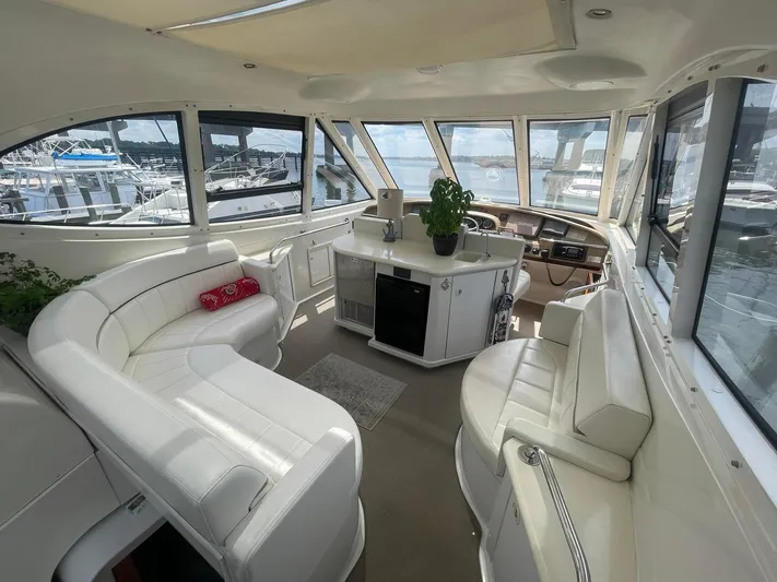  Yacht Photos Pics Interior of 2000 Carver 506 Motor Yacht with white seating and panoramic windows.