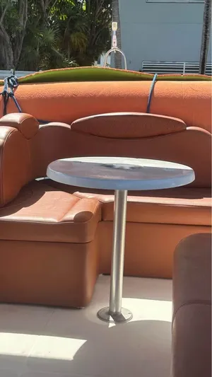 Nirvana Yacht Photos Pics 2004 Cranchi Atlantique 40 Flybridge with leather seating and round table.