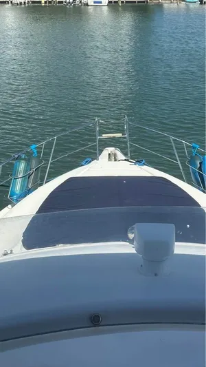 Nirvana Yacht Photos Pics 2004 Cranchi Atlantique 40 Flybridge yacht on calm water, view from the deck.