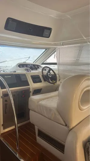 Nirvana Yacht Photos Pics Interior of 2004 Cranchi Atlantique 40 Flybridge yacht with steering wheel and control panel.