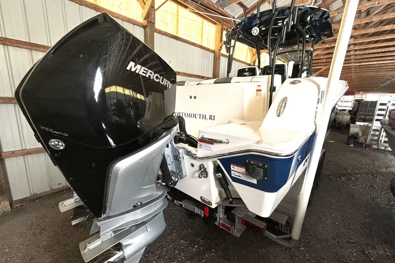  Yacht Photos Pics 2019 Wellcraft 302 Fisherman boat with Mercury Verado engine in a storage facility.