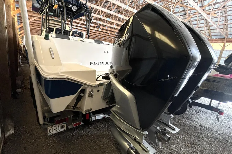  Yacht Photos Pics 2019 Wellcraft 302 Fisherman boat with dual Mercury Verado engines in a storage facility.