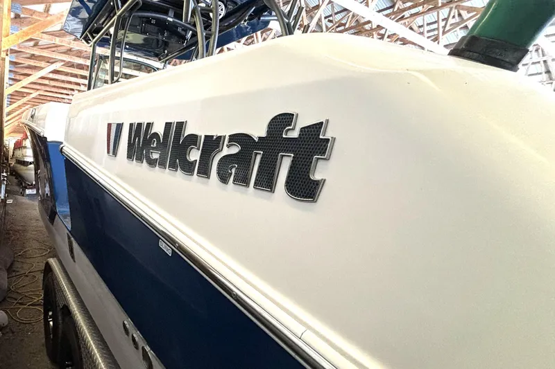  Yacht Photos Pics 2019 Wellcraft 302 Fisherman boat in storage, showcasing sleek design and branding.