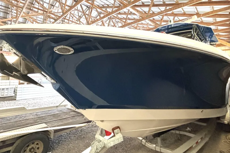  Yacht Photos Pics 2019 Wellcraft 302 Fisherman boat in storage, showcasing sleek blue hull design.