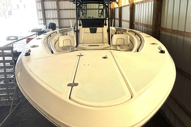  Yacht Photos Pics 2019 Wellcraft 302 Fisherman boat in storage, showcasing spacious deck and seating.