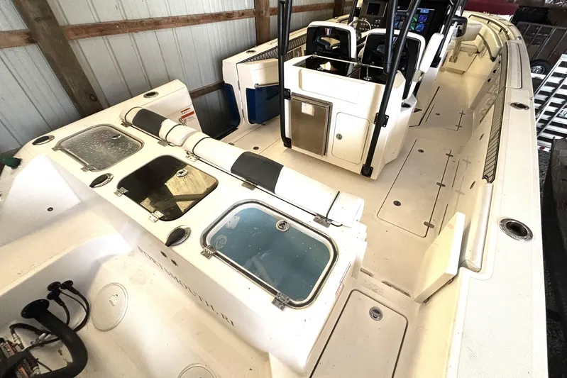  Yacht Photos Pics 2019 Wellcraft 302 Fisherman boat interior with seating and storage compartments.