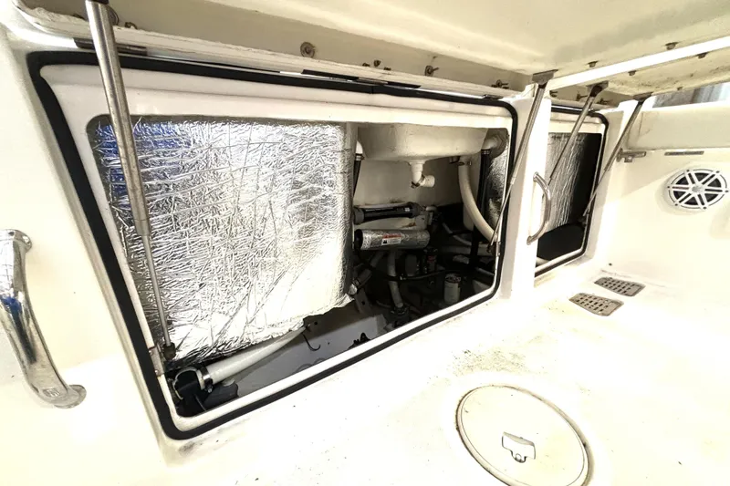  Yacht Photos Pics 2019 Wellcraft 302 Fisherman boat interior with open storage compartments and visible insulation.