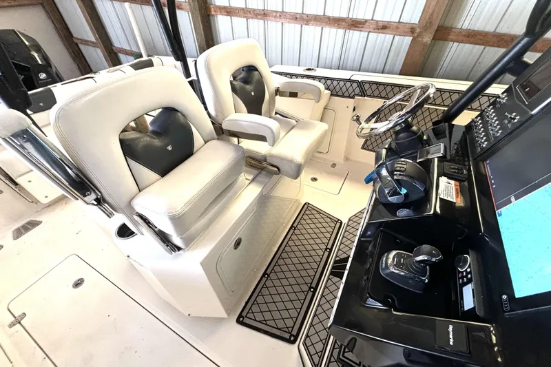  Yacht Photos Pics 2019 Wellcraft 302 Fisherman boat interior with helm, steering wheel, and seating.