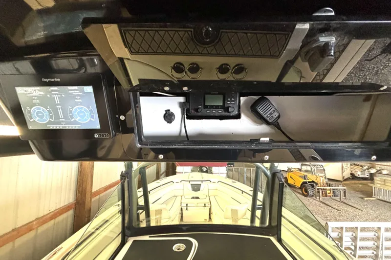  Yacht Photos Pics 2019 Wellcraft 302 Fisherman boat dashboard with Raymarine display and communication equipment.