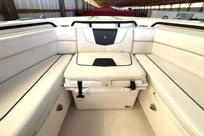  Yacht Photos Pics 2019 Wellcraft 302 Fisherman boat interior with white cushioned seating and storage.