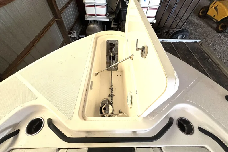  Yacht Photos Pics 2019 Wellcraft 302 Fisherman boat storage compartment open in a garage setting.