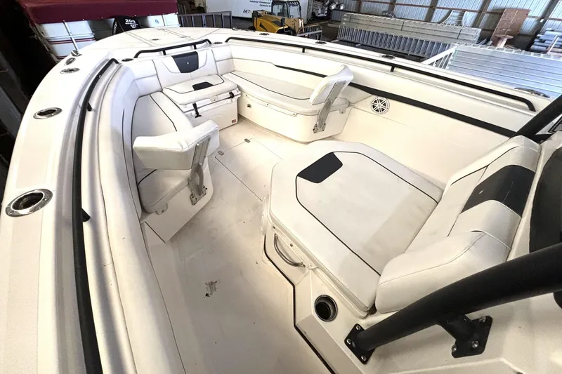  Yacht Photos Pics 2019 Wellcraft 302 Fisherman boat interior with white seating and storage compartments.