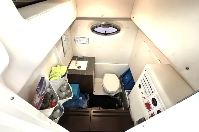  Yacht Photos Pics 2019 Wellcraft 302 Fisherman cabin with sink, toilet, and storage compartments.