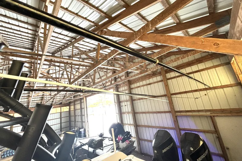  Yacht Photos Pics 2019 Wellcraft 302 Fisherman boat stored in a wooden garage with Mercury engines.