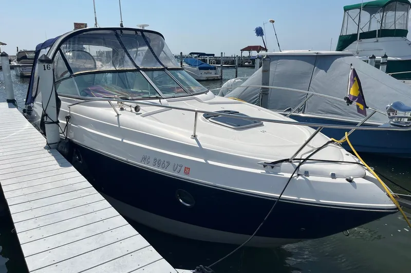  Yacht Photos Pics 2020 Rinker 290 EX boat docked at marina, featuring sleek design and canopy.