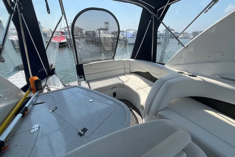  Yacht Photos Pics 2020 Rinker 290 EX boat interior with white seating and marina view.