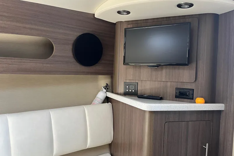  Yacht Photos Pics 2020 Rinker 290 EX interior with TV, modern cabinetry, and seating area.