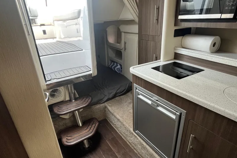  Yacht Photos Pics Interior of 2020 Rinker 290 EX boat with kitchenette and cabin area.