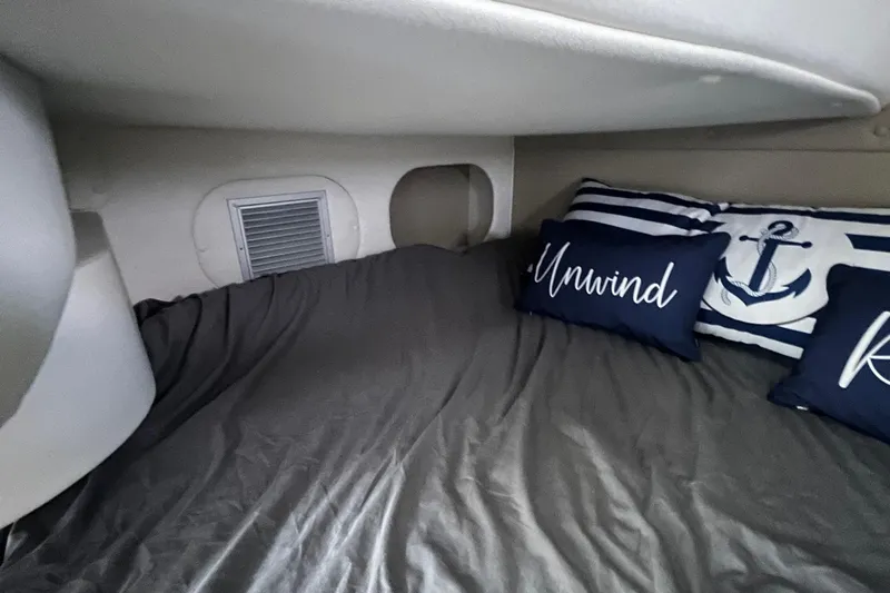  Yacht Photos Pics Cozy cabin interior of 2020 Rinker 290 EX with nautical-themed pillows.