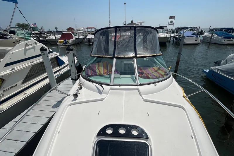 Yacht Photos Pics 2020 Rinker 290 EX boat docked at marina, surrounded by other vessels.