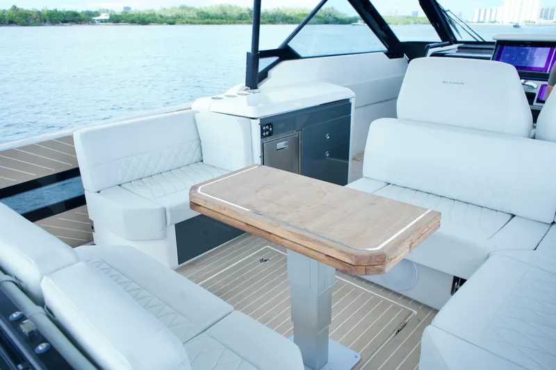 Sierra Tango VI Yacht Photos Pics 2025 Saxdor 400 GTO luxury boat interior with white seating and wooden table.
