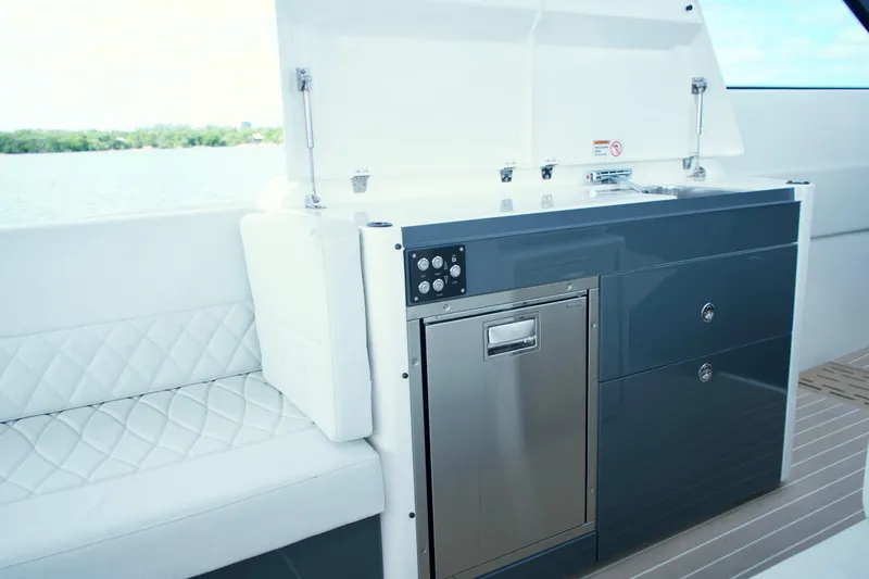 Sierra Tango VI Yacht Photos Pics 2025 Saxdor 400 GTO yacht interior with sleek kitchenette and seating.