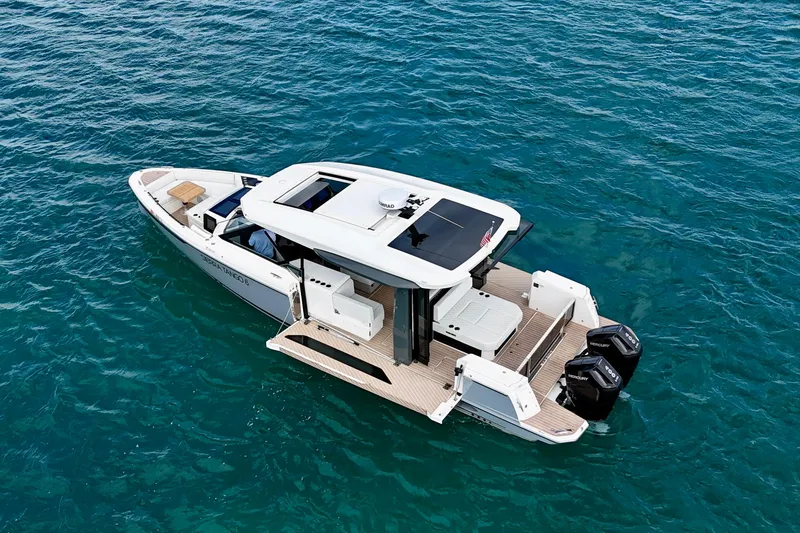 Sierra Tango VI Yacht Photos Pics 2025 Saxdor 400 GTO luxury boat on clear blue water, rear view.