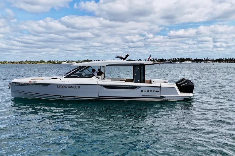 Sierra Tango VI Yacht Photos Pics 2025 Saxdor 400 GTO luxury boat cruising on a calm sea under a cloudy sky.