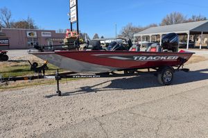2025 Tracker Pro Team 175 boat on trailer, parked outdoors, featuring red and gray design.