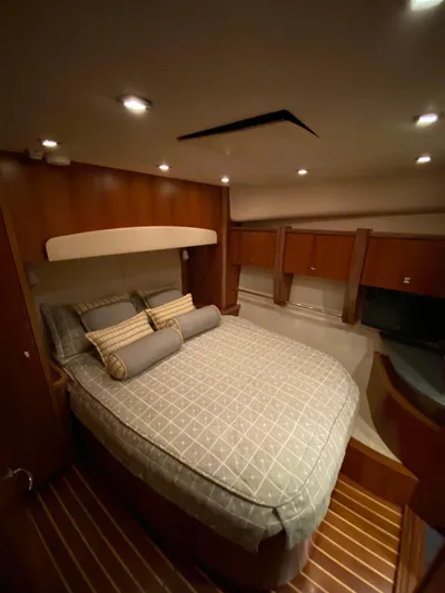  Yacht Photos Pics Luxurious bedroom in 2012 Tiara Yachts 48 Convertible with elegant wood finishes.