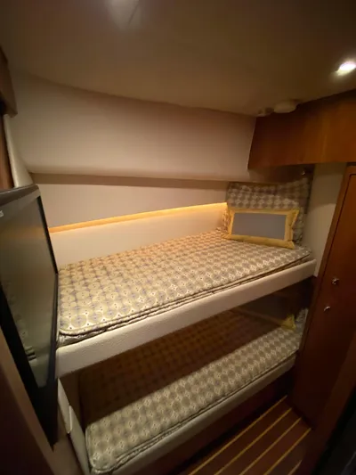  Yacht Photos Pics 2012 Tiara Yachts 48 Convertible cabin with bunk beds and warm lighting.
