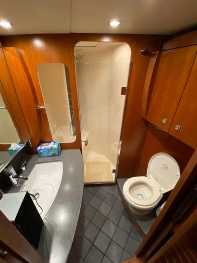  Yacht Photos Pics Luxurious bathroom in 2012 Tiara Yachts 48 Convertible, featuring modern fixtures and elegant wood finishes.