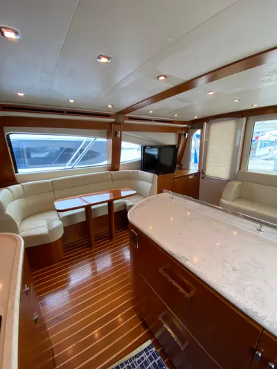  Yacht Photos Pics Luxurious interior of 2012 Tiara Yachts 48 Convertible with elegant wood finishes and plush seating.