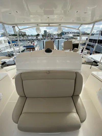  Yacht Photos Pics 2012 Tiara Yachts 48 Convertible interior with beige seating and marina view.