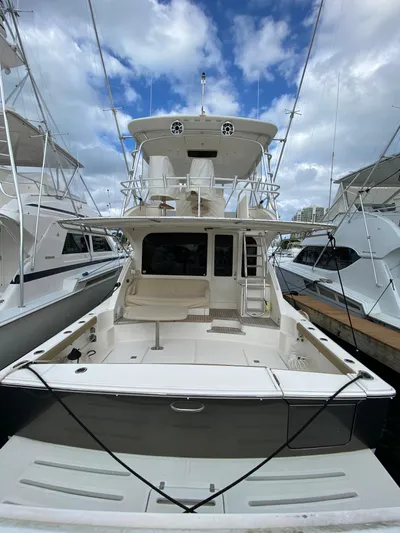  Yacht Photos Pics 2012 Tiara Yachts 48 Convertible docked under a cloudy sky.