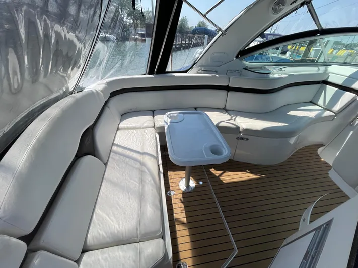  Yacht Photos Pics 2013 Rinker 310 Express Cruiser interior with white seating and wooden flooring.